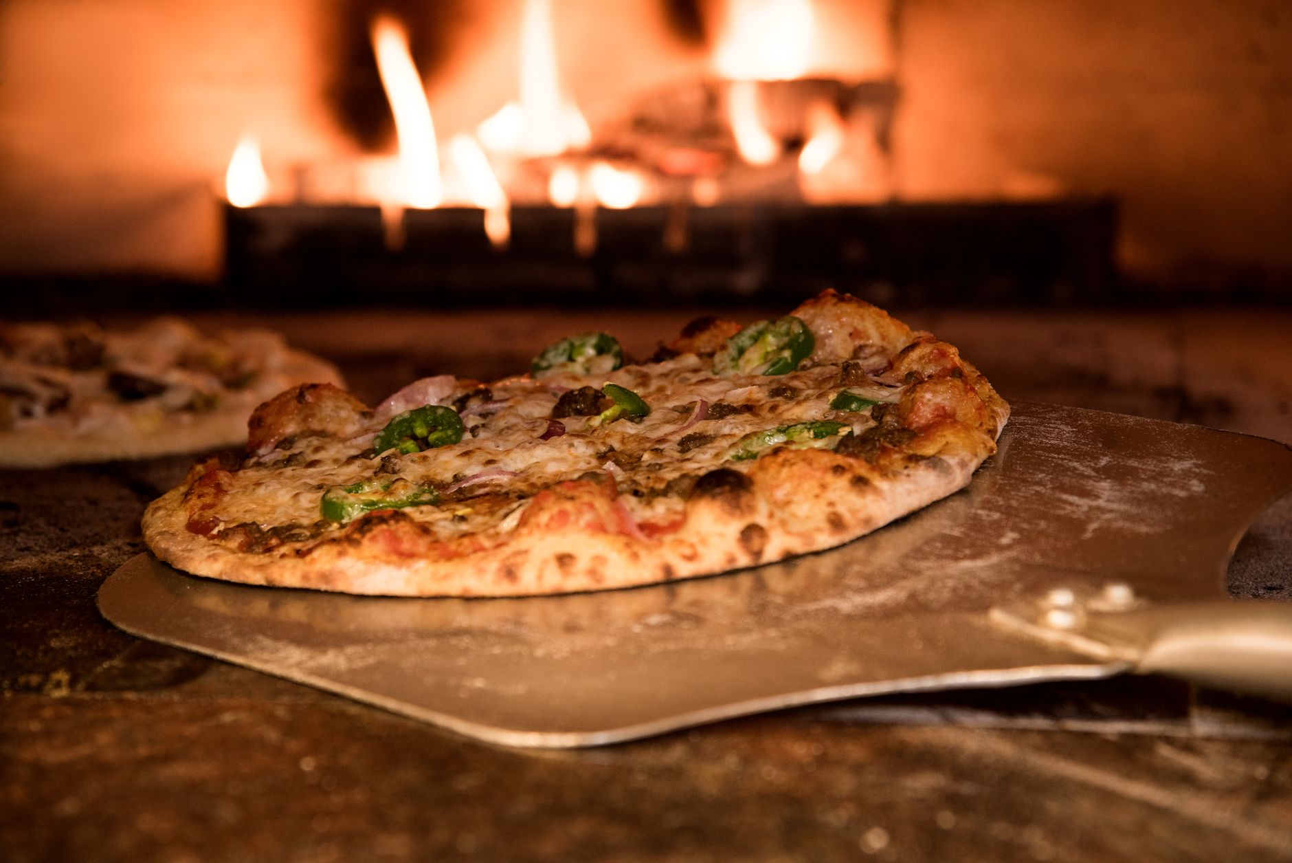 A wood-fired pizza oven in a restaurant kitchen