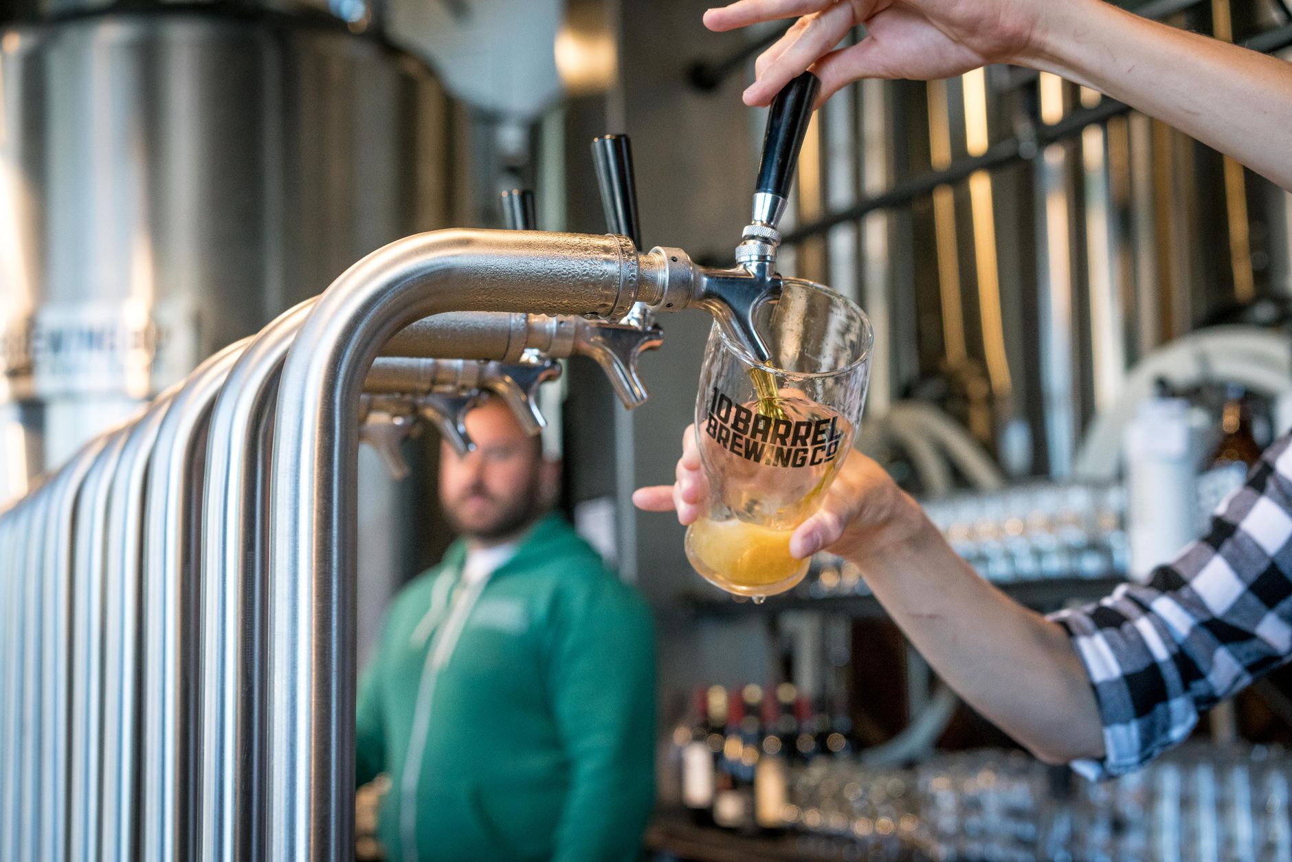 Beer being poured at a brewery taproom bar