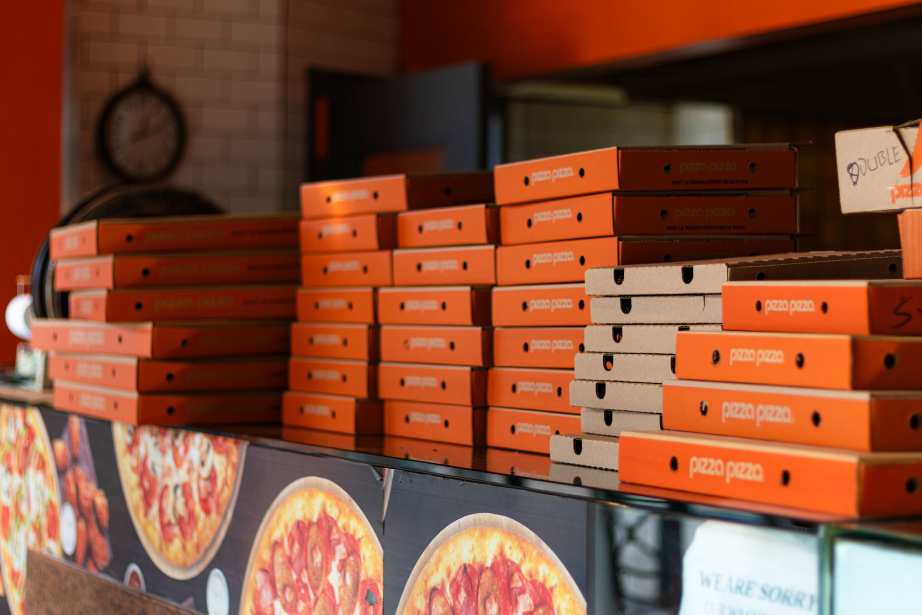 Stacked pizza takeout boxes in a pizzeria