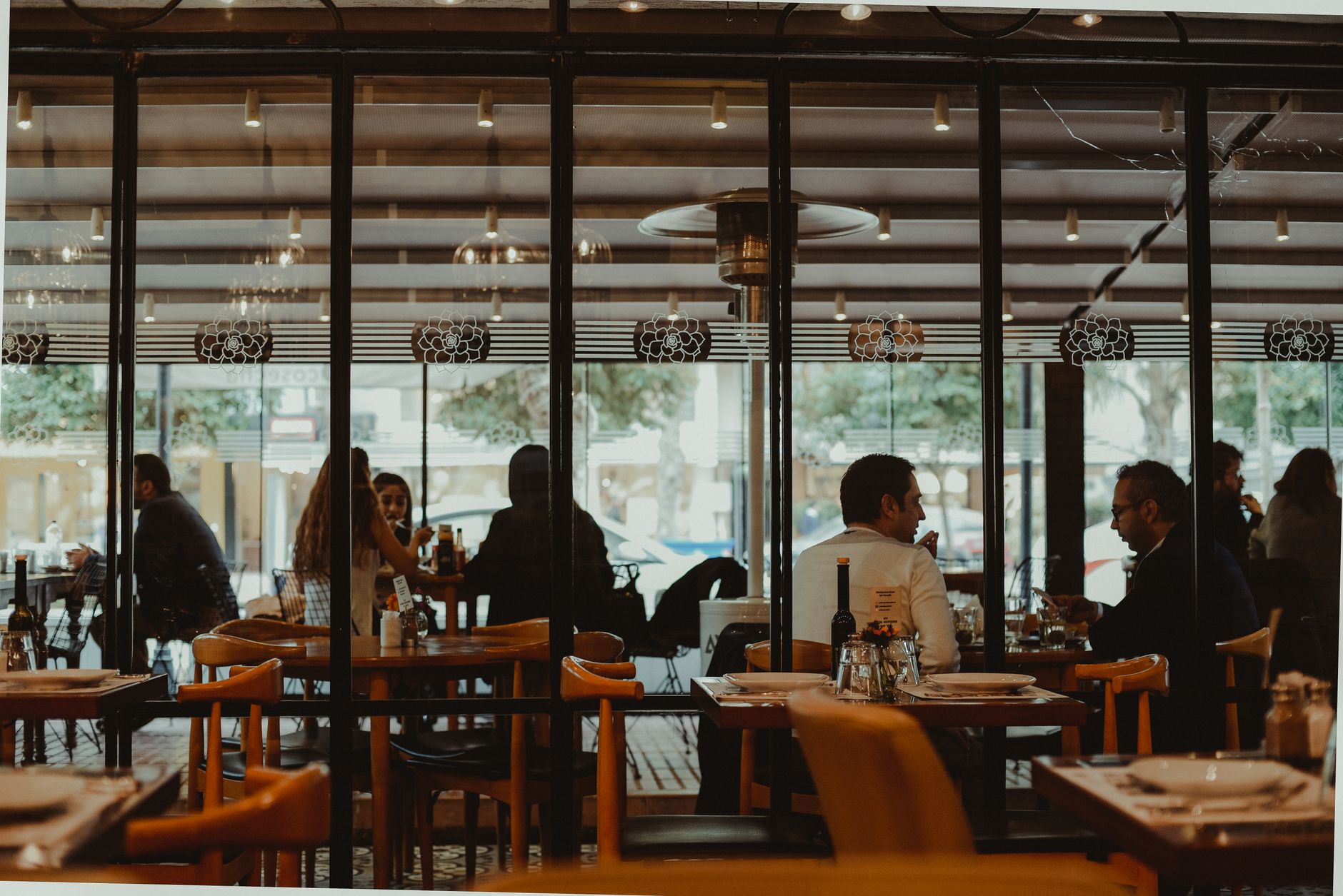 Diners enjoying a meal in a bustling restaurant interior