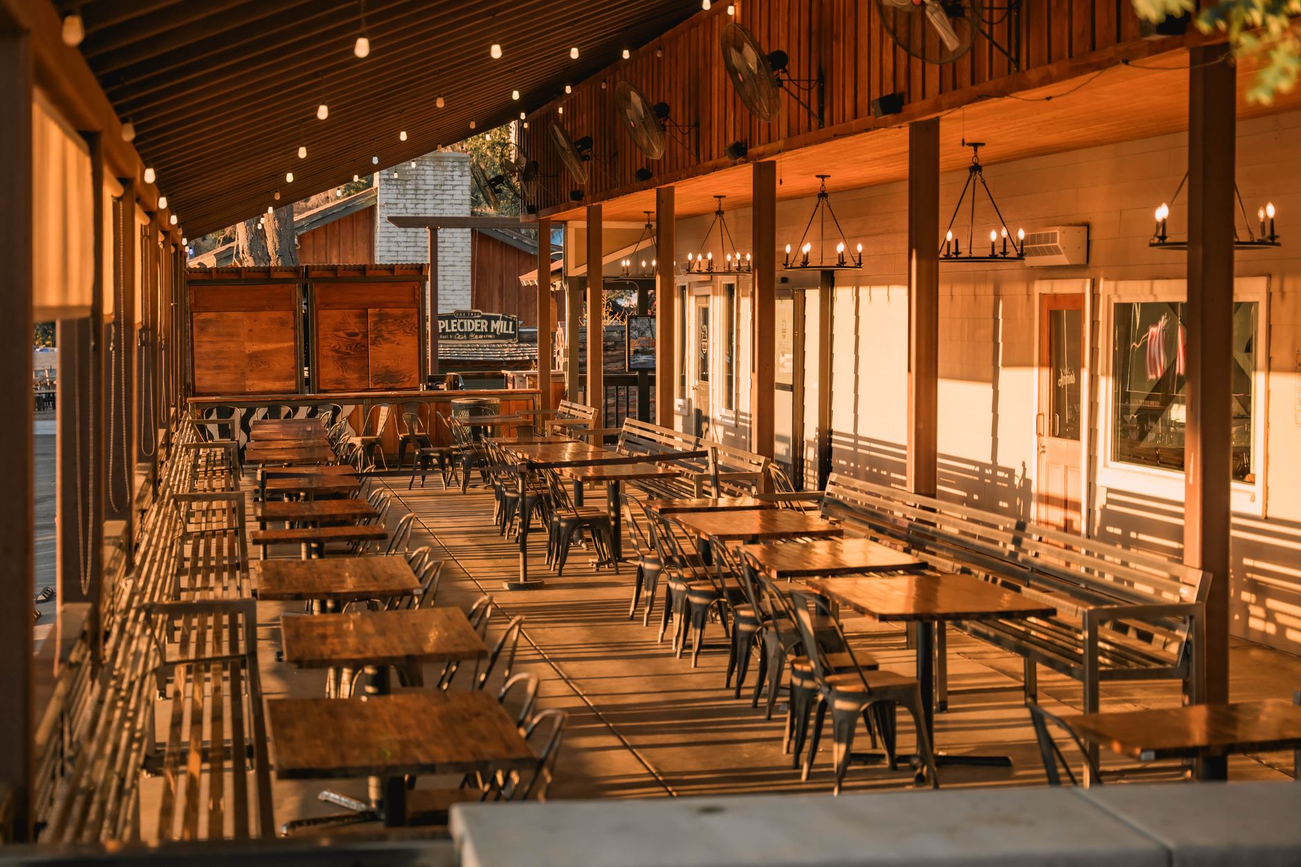 Warm outdoor restaurant patio with string lights at night