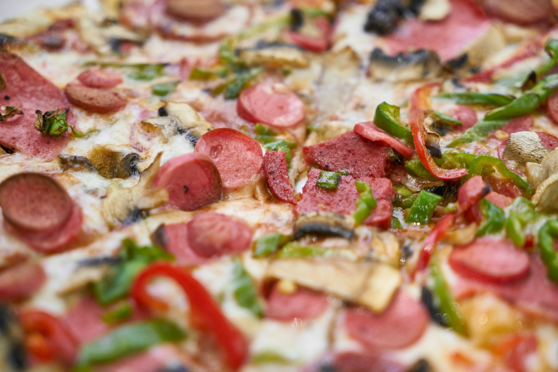 Close-up of a pepperoni pizza slice with melted cheese