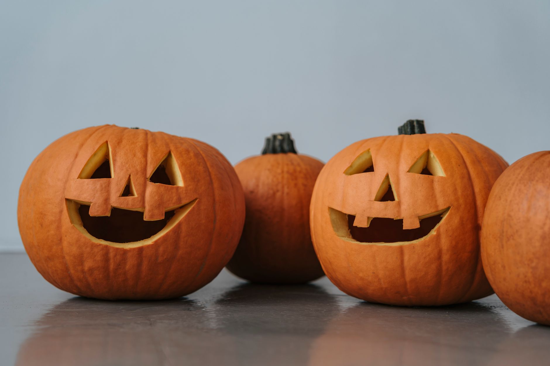 Carved jack-o-lanterns set out for a Halloween gathering