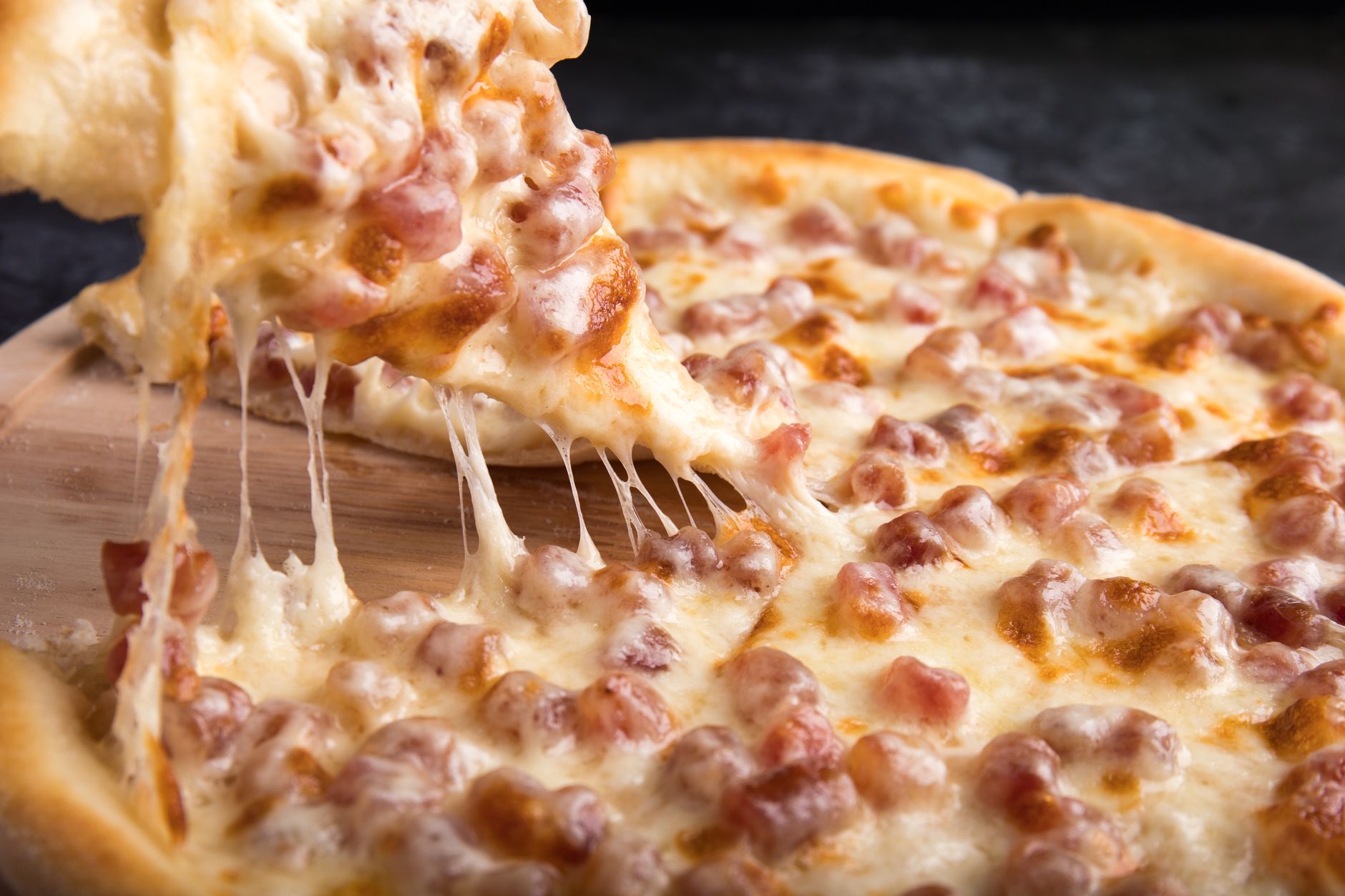 Close-up of a pepperoni pizza slice with melted mozzarella cheese