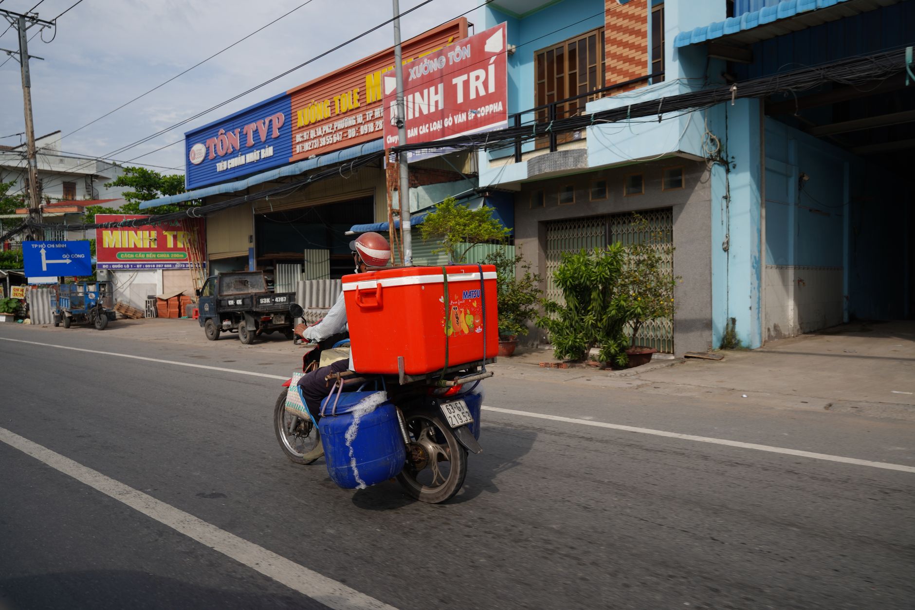 Delivery rider on a motorbike carrying food on a city street